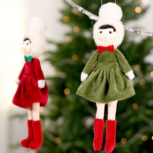 Nordic plush Christmas girl doll pendants hanging on a decorated tree with festive lights