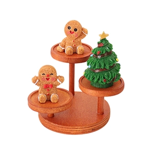 Three-tier wooden Christmas display stand with gingerbread man and mini tree figurines