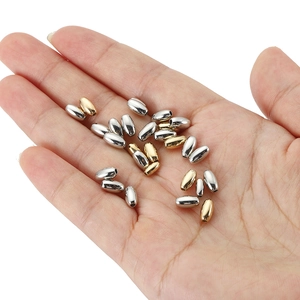 Golden and silver oval CCB spacer beads held in hand for DIY jewelry making