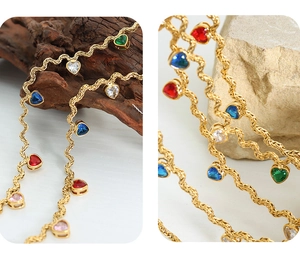 Macro detail of gold twisted rope chain with colorful heart zircon gemstone pendants