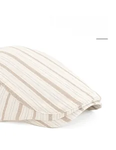 Detail of striped newsboy hat featuring textured fabric and flexible wide brim design