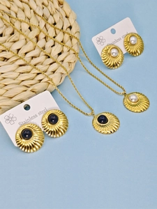 Detail of vintage gold textured shell jewelry set with deep blue and white stones