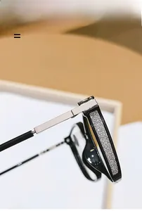 Detail of black eyewear frames with silver glitter inlay and modern metal temple joints