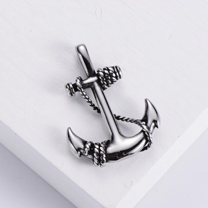 Polished 304 stainless steel anchor pendant with rope detail on stone surface