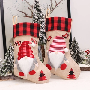 Set of two rustic burlap Christmas stockings featuring cute gnome appliques and plaid cuffs