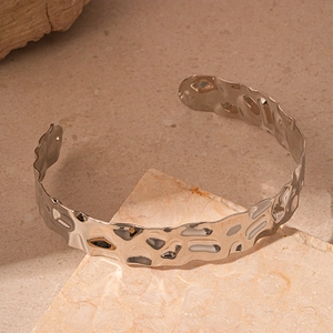Close-up of silver metal choker featuring a unique hammered texture and minimalist design