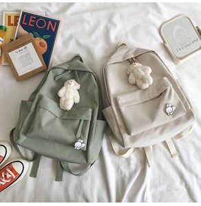 Minimalist Harajuku backpacks in green and beige with cute plush bear charms and pins