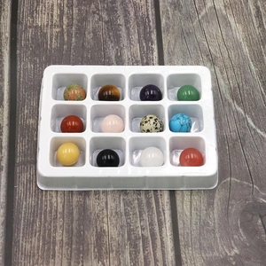 Set of 12 natural crystal spheres in various healing stones on a display tray