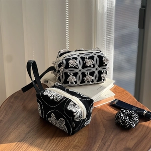 Minimalist black canvas tote bags with elegant white embroidery and fringe details