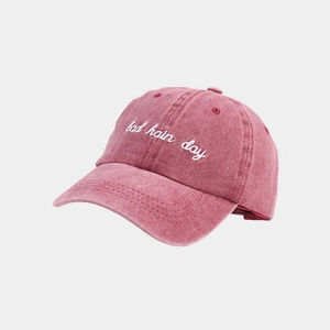 Detail of washed cotton canvas texture and 'bad hair day' embroidery on a vintage cap