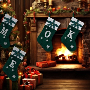 Detail of dark green knit Christmas stocking with white snowflake embroidery and plaid bow