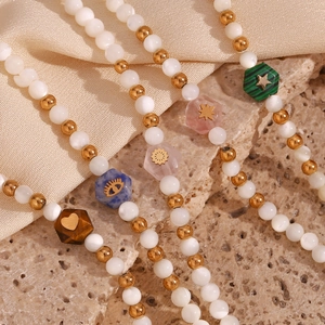 Beaded bracelet with white pearls, gold spacers and hexagonal colorful natural stones
