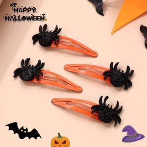 Set of four black glitter spider hair clips on orange metal for Halloween party styling