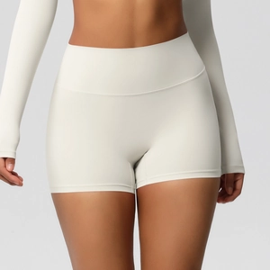 Detail showing high-waisted seamless cream yoga shorts with elastic fabric texture