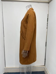 Detail view of long-sleeved caramel wool coat with notched lapels and side pockets