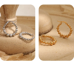 Detail of beaded hoop earrings in gold and silver with matte and polished finishes