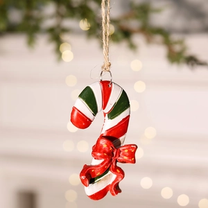 Close-up of red and green candy cane ornament with a bow on a Christmas tree