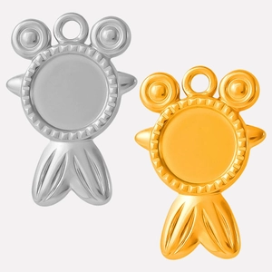 Close-up of gold and silver sea-themed charms with gear-edged settings for DIY jewelry