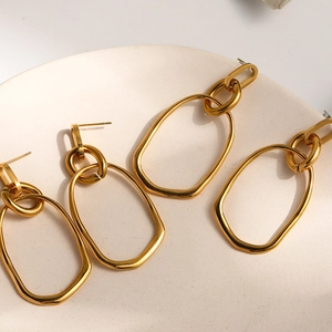 Fashionable layered gold oval dangle earrings for women in a minimalist punk style