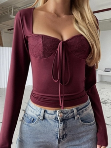Detail view of burgundy Y2K long sleeve lace top with bustier style and front lacing