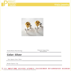 Detailed macro of two-tone rose flower stud earrings in copper with gold and silver plating