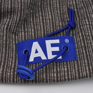 Macro shot of grey-brown knit fabric with blue AE brand label and elastic drawstring