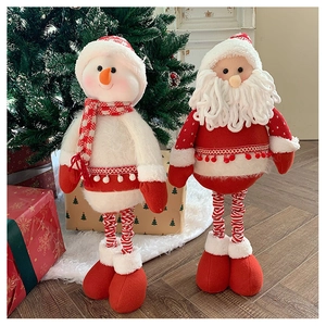 Detail of telescopic Santa and snowman plush dolls standing by a Christmas tree