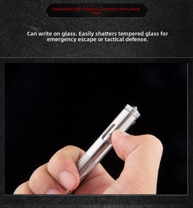 Detail of sliding bolt mechanism on stainless steel tactical pen with tungsten head