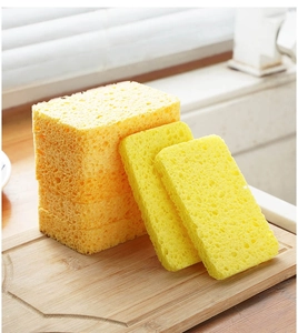 Macro detail of yellow wood pulp cotton sponge showing porous texture and thickness variety