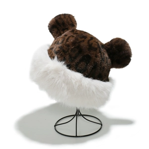 Detail of plush leopard print winter hat with cute bear ears and white faux fur trim