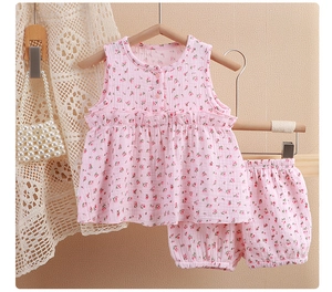Detailed texture of baby girls floral cotton muslin sleeveless top and bloomers set