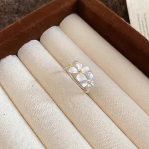 Elegant silver flower open ring with white matte petals and yellow center detail