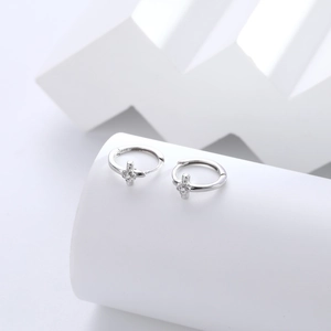 Macro shot of S925 sterling silver cross earrings featuring cubic zirconia and S925 hallmark