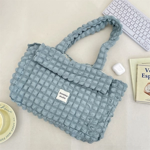 Close-up of light blue bubble textured canvas tote bag with soft ruffled fabric detail