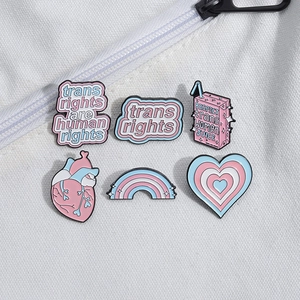 Transgender rights enamel pins set featuring heart and rainbow milk box on white canvas