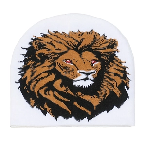 Detail of white knit beanie with a lion head pattern and intricate jacquard texture