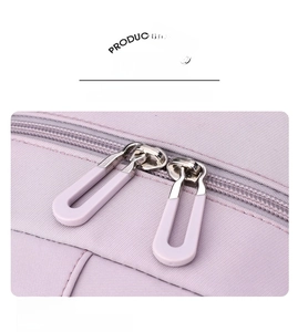 Close-up of smooth two-way metal zippers on a light purple waterproof nylon backpack
