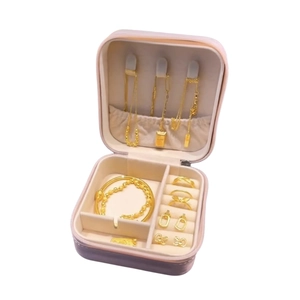 Portable jewelry box in pink purple leather with velvet interior and storage compartments