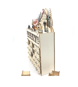 Detail of wooden 24-day advent calendar with carved village scene and Santa Claus