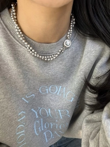 Detail view of double-layer gray pearl necklace with square mother of pearl pendant