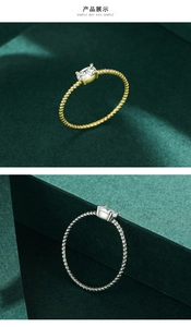 Macro detail of twisted rope silver rings featuring a classic four-prong solitaire zircon