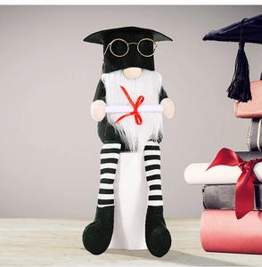 Detail of graduation gnome doll featuring black academic cap and golden spectacles decor