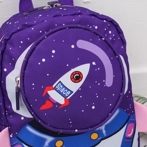 Close-up of a purple toddler backpack with a 3D rocket design and space theme graphics