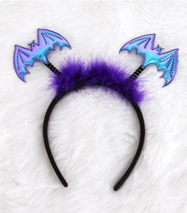 Macro detail of Halloween headband with purple feathers and laser metallic bats