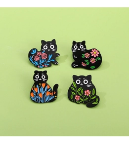 Detailed set of black cat enamel pins with colorful flower patterns on light green background