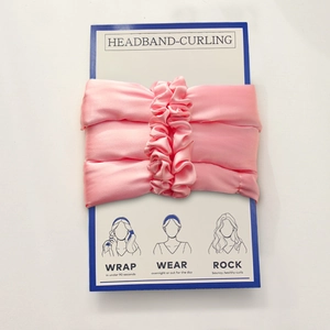 Pink silk heatless hair curler set on packaging with step-by-step usage instructions