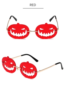 Detail view of red pumpkin-shaped Halloween sunglasses with metal temples and red lenses