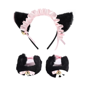 Detail shot of plush black and pink cat ear headband with bell wristbands and satin ribbons
