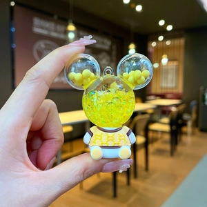 Luminous bear keychain with yellow liquid sand and designer pattern in acrylic bottle