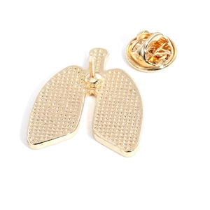 Golden anatomical lung shape alloy brooch with secure butterfly clasp on white background